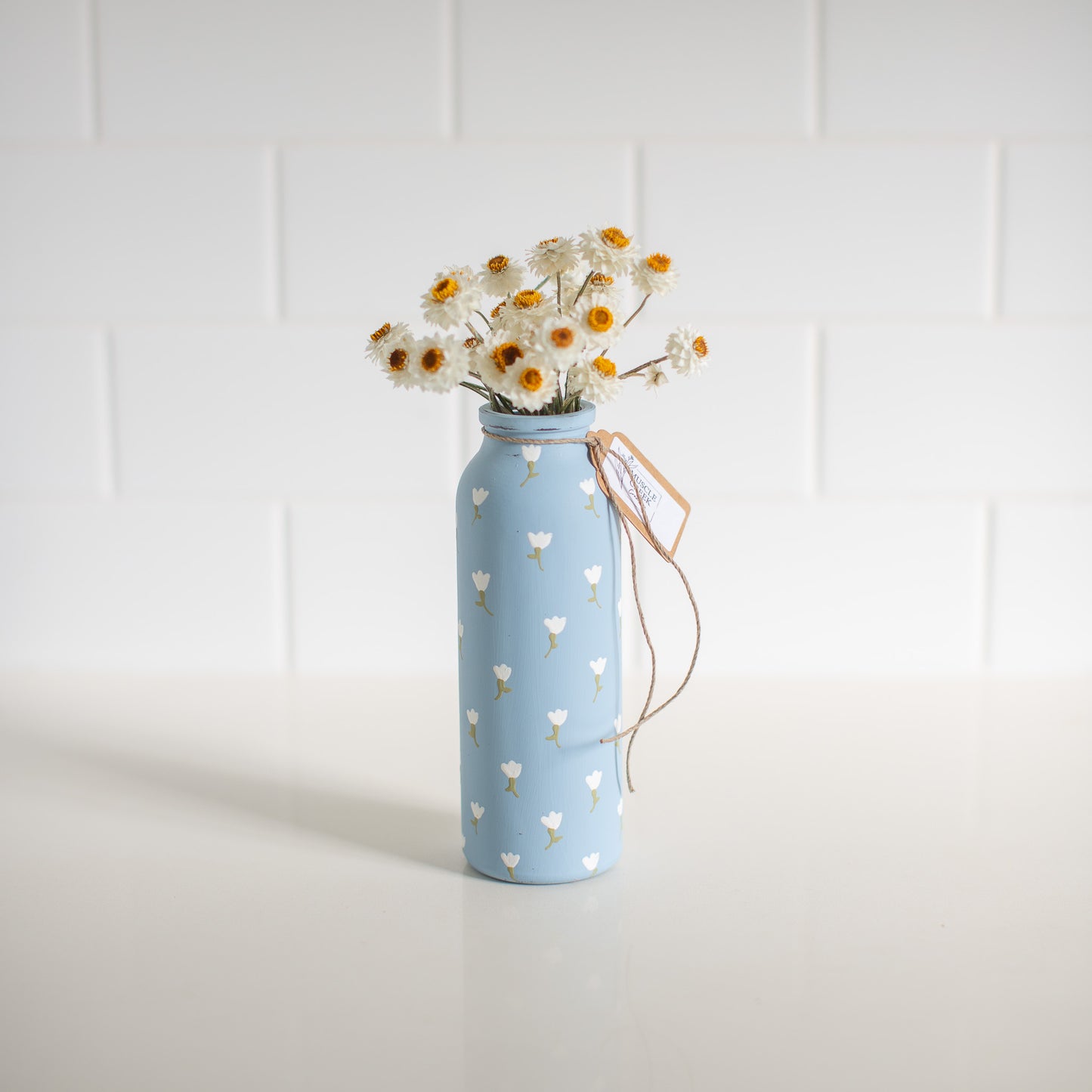 Everlasting Daisies in Blue Vase